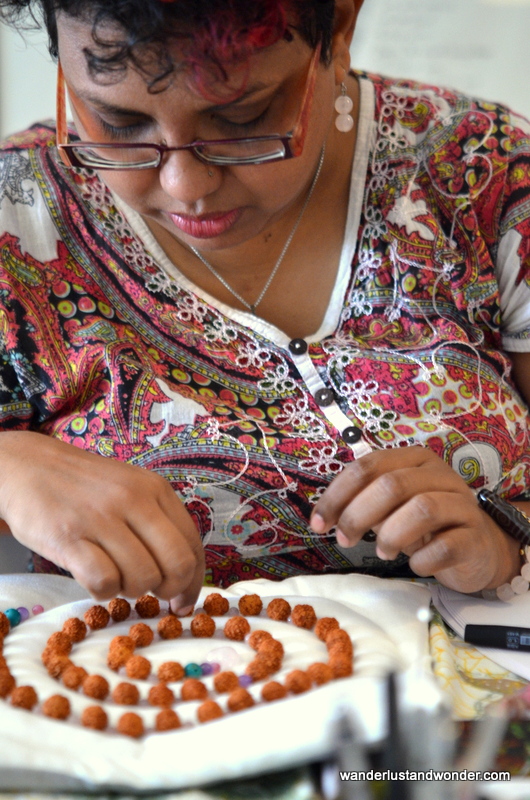 Fellow student Sumitra organizing her beads.