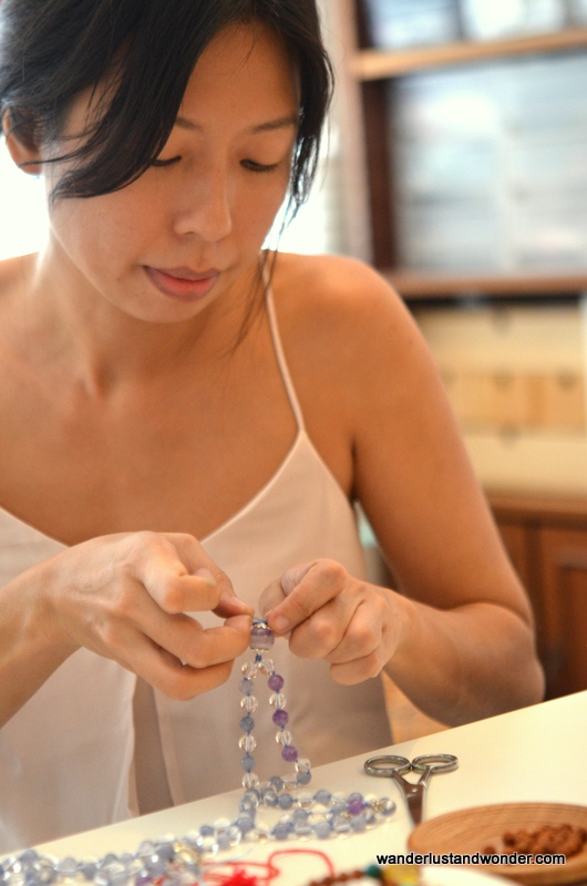 Jiawen demonstrating how to tie the knots.